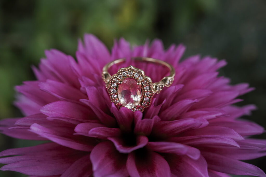 up close photo of an engagement ring on a flower