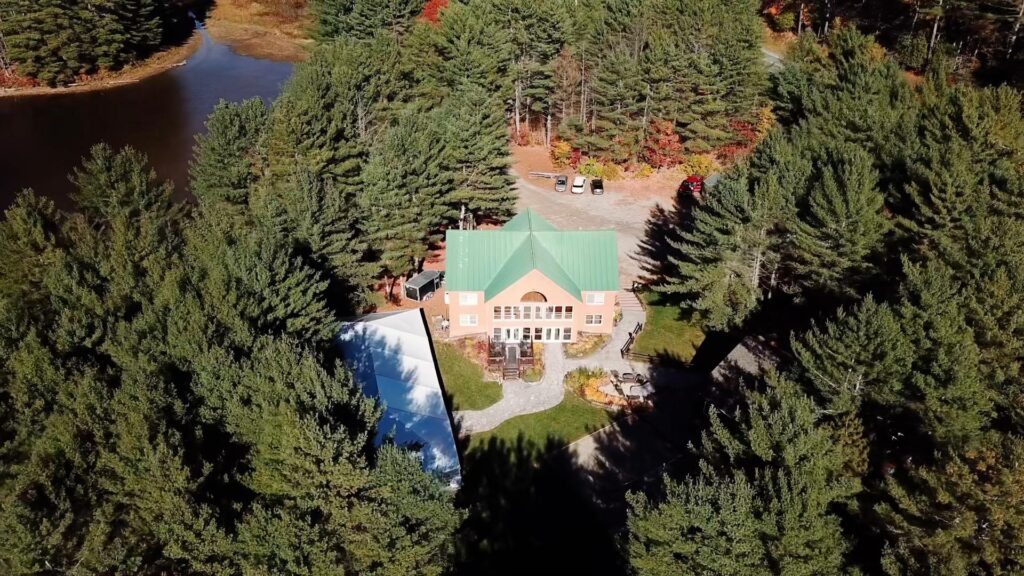 aerial drone photo of wedding venue surrounded by forest