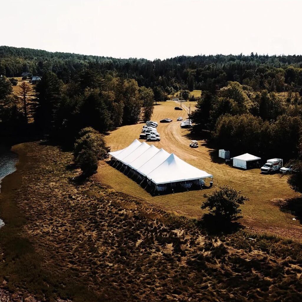 aerial drone photo of wedding reception tent in field