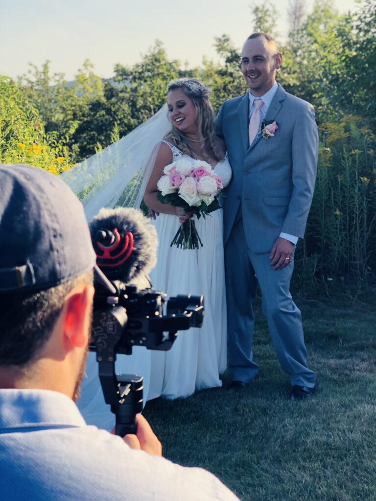 photo of photographer taking a photo of a bride and groom